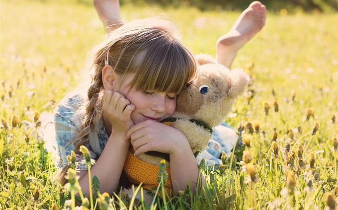 Childhood and chocolate test: girl with teddy bear