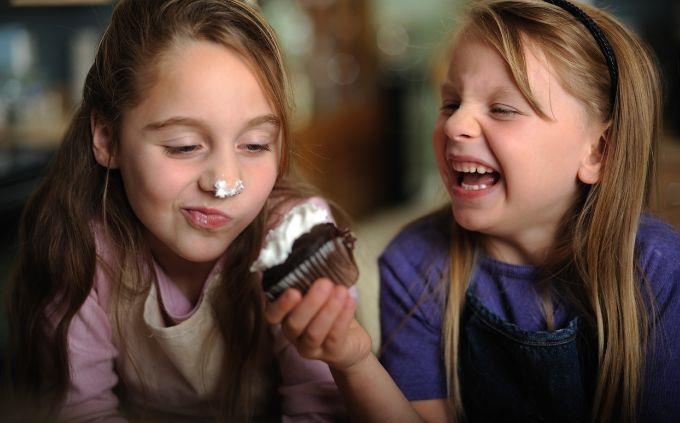 Are you hero, harp or anti hero: A girl pushes a cake to another girl