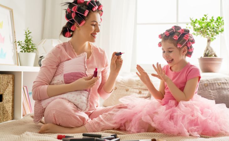 At what age can children use cosmetics and skincare products: A girl and her mother applying nail polish