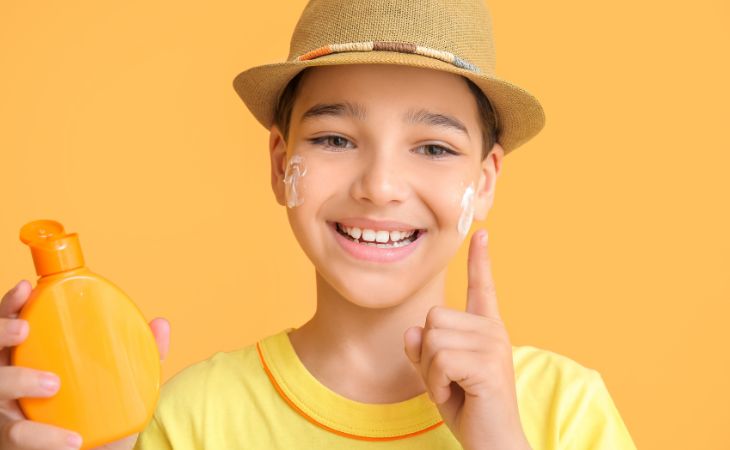 At what age can children use cosmetics and skincare products: A child applying sunscreen to their face