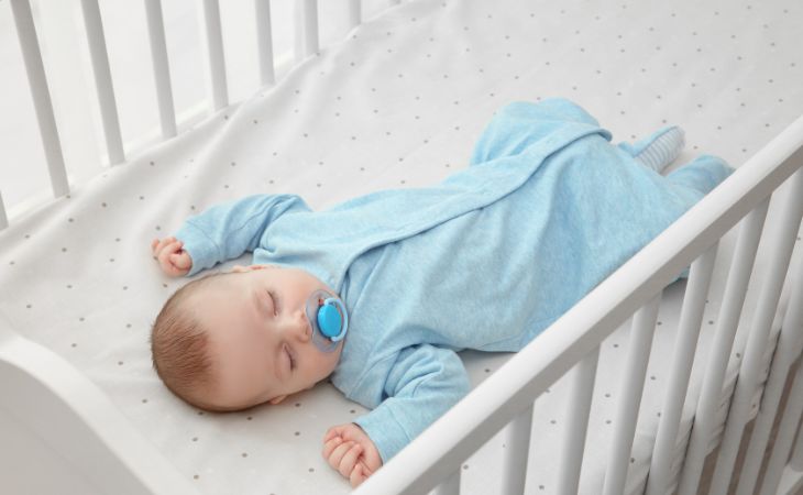 How parents harm their children’s sleep: a baby sleeping in a crib