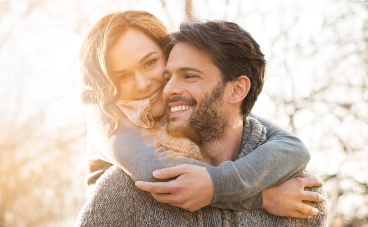 What to do if you feel lonely in marriage: Woman hugging her man from behind