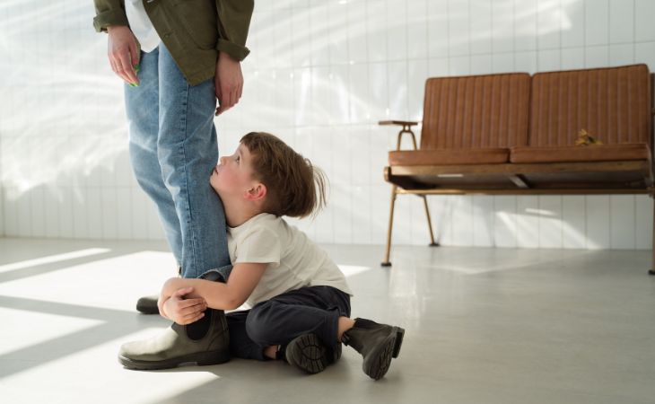 Why the child behaves less nicely specifically with you: A child clinging to a mother’s leg