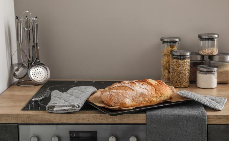 Things not to keep near the stove: Oven mitts on the stove