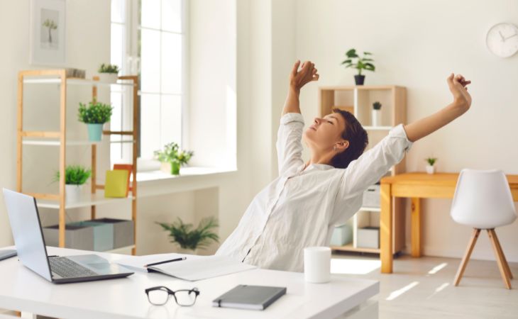 What are Micro-Breaks: A woman stretching on her work chair