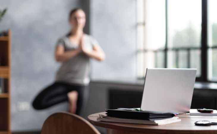 What are Micro-Breaks: A woman doing yoga in her home office
