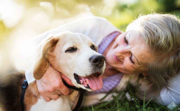 How pets keep our heart healthy: An elderly woman hugging a dog