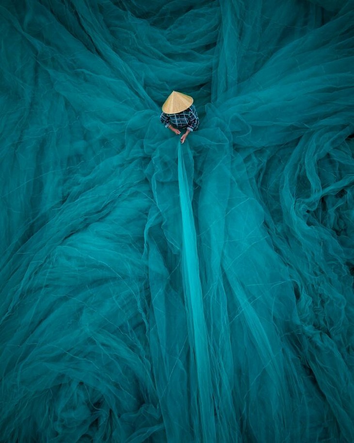 Photos from the 1839 Awards photography competition: Man standing inside a giant fishing net