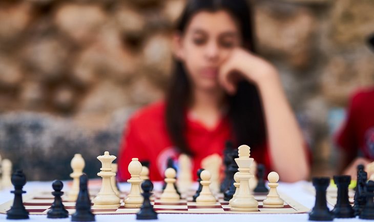 Emotions and Decision-Making: A Young Woman Facing a Chessboard