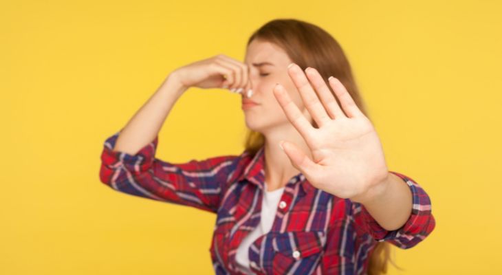 How to identify emotions and the message they convey: A woman covering her nose and putting a hand in front of her