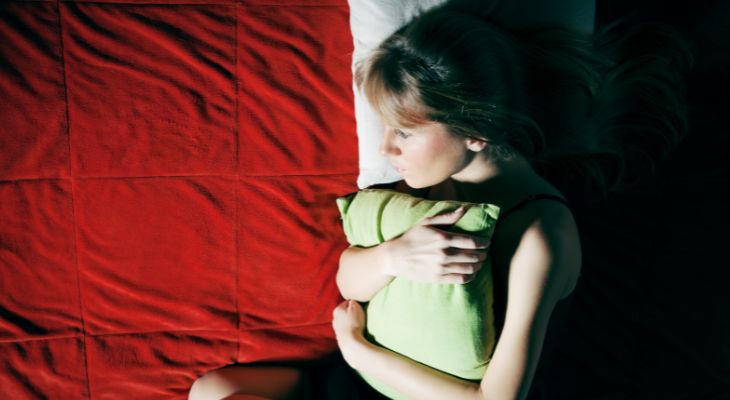 How to identify emotions and the message they convey: A woman hugging a pillow