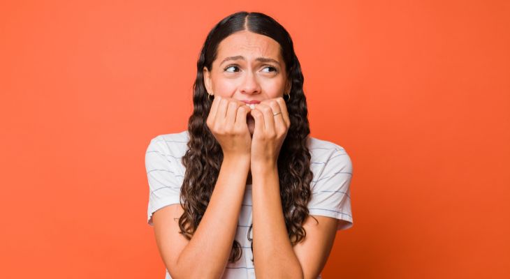 How to identify emotions and the message they convey: A woman biting her nails