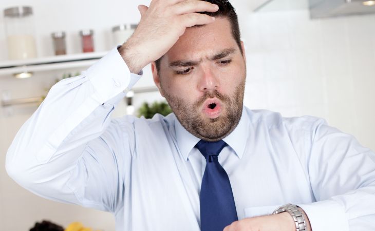 Advantages of people who are late: A man looking at his watch and appearing worried