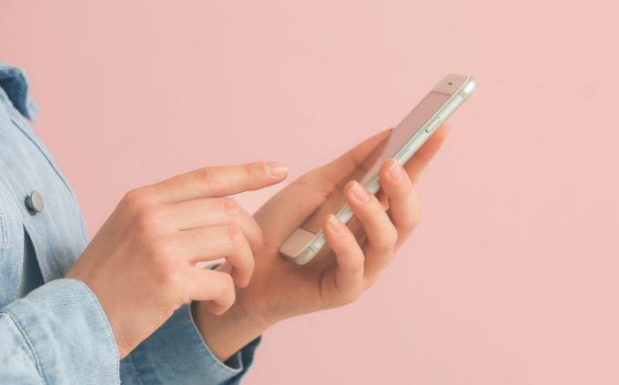 Which social network fits your personality: Woman uses a mobile phone