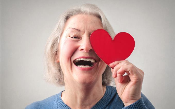 Do you fall in love quickly? An older woman holds a heart