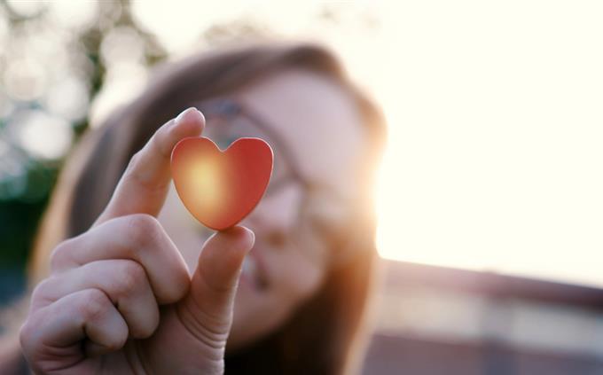 Do you fall in love quickly? A woman holds a heart