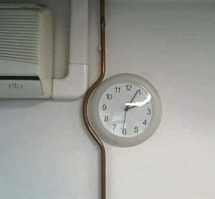 Failed designs and funny signs: Curved pole around a wall clock