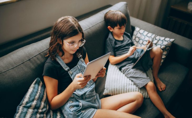 How to prevent children from becoming addicted to screens: Children sitting in front of tablets