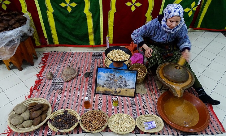 Uses of argan oil: A mysterious woman preparing and selling argan oil
