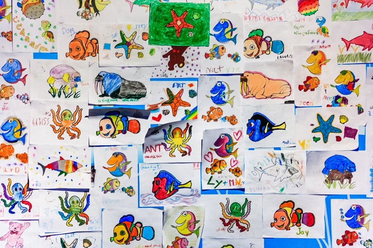 Small parental gestures for children: Colored drawings hanging on a wall