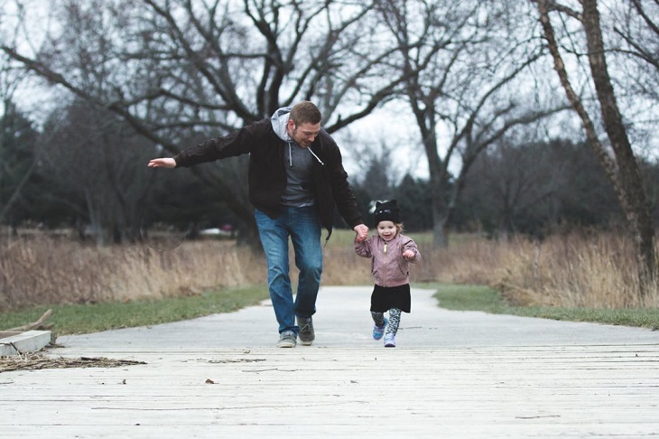Small parental gestures for children: A father and daughter running on a park trail