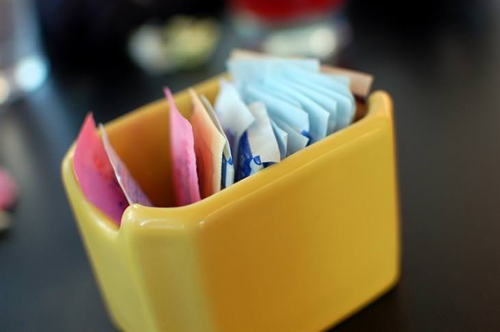 The risk of consuming aspartame: a sugar container on a cafe table
