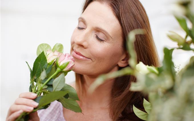Emotional Limits Test: A woman smells a flower