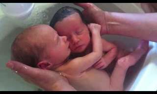 Twins Holding Each Other During Bath